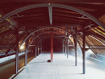 Empty footpath in illuminated building