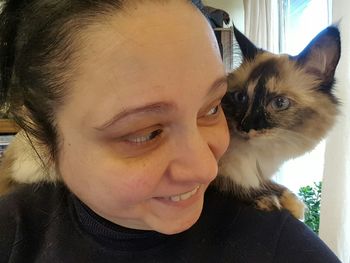 Portrait of man with cat