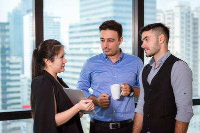 Colleagues discussing in office
