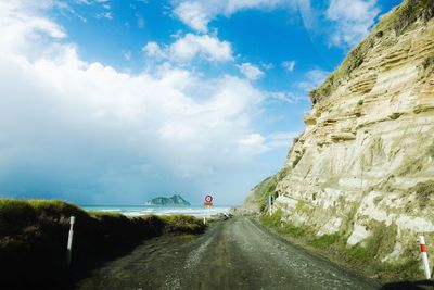 Road by street against sky