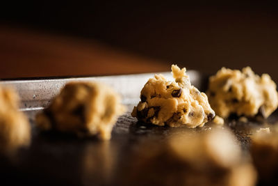 Chocolate chip cookie dough on a stainless steal cookie sheet
