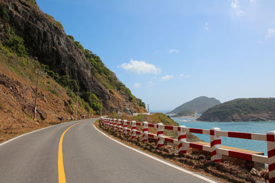 Road by mountain against sky