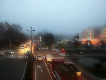 Cars on road against sky during rainy season