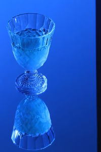 Close-up of blue glass on table