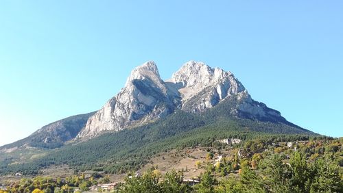 Scenic view of mountains against clear blue sky