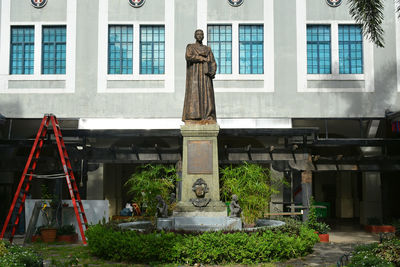 Statue against building in city