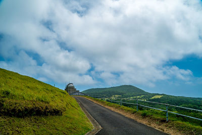 Empty road along countryside landscape