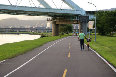 Rear view of man on bridge over road