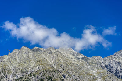 Base jumpers over mountain peak - antholzersee - lago di anterselva - south tyrol südtirol