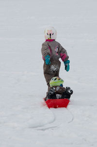 Woman standing on snow covered landscape