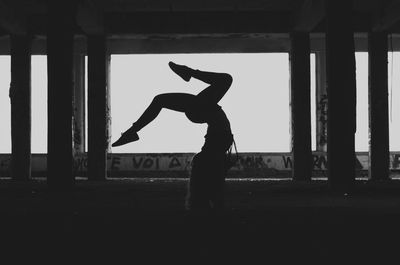 Woman with arms outstretched against wall