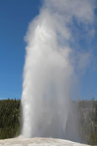 Scenic view of waterfall against sky