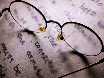 High angle view of eyeglasses on book