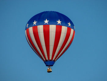 Low angle view of hot air balloon against clear blue sky