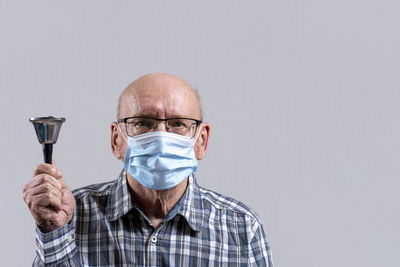 Portrait of man wearing mask against white background