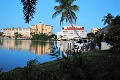 Buildings by sea against sky