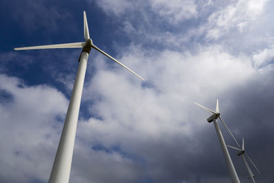 Low angle view of windmill against cloudy sky