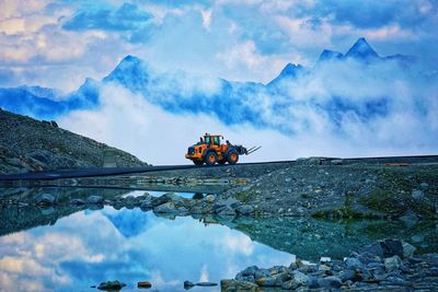 Scenic view of clouds over mountains against sky