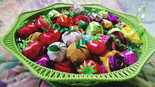 Multi colored chocolates in basket on table