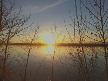 Scenic view of lake at sunset