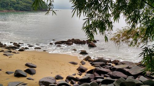 Rocks on beach by sea