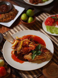 High angle view of fried fish sweet and sour in plate on table