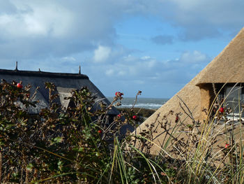 Scenic view of building by sea against sky