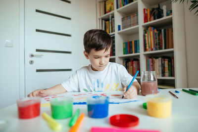 Boy wearing sunglasses at home