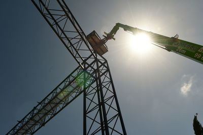 Low angle view of crane against sky