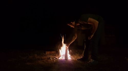 Man in illuminated fire at night