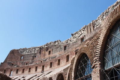 Low angle view of historical building against clear blue sky