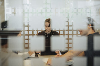 Young students discussing while studying together in university