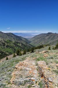 Scenic view of mountains against clear blue sky