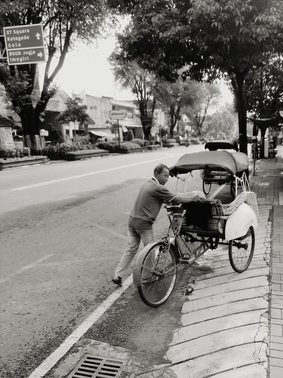 MAN RIDING BICYCLE ON STREET