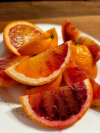 Close-up of orange slices in plate on table
