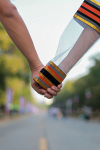 Cropped image of couple holding hands outdoors