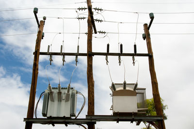 Low angle view of electricity pylon against sky