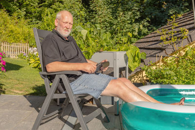 Man cooling down his feet in a pool