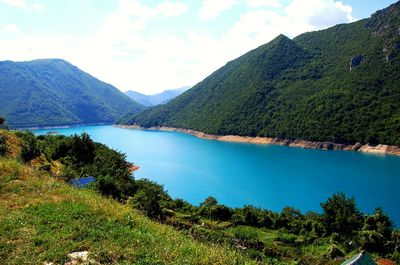 Scenic view of lake and mountains against sky