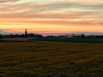 Scenic view of agricultural field against dramatic sky