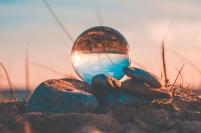 Close-up of crystal ball on rock