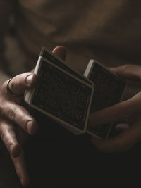 Close-up of man holding cards