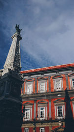 Low angle view of building against cloudy sky