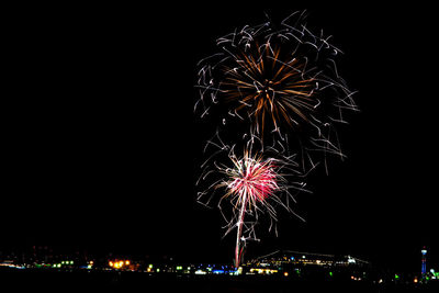 Low angle view of firework display at night