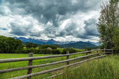 Scenic view of field against cloudy sky