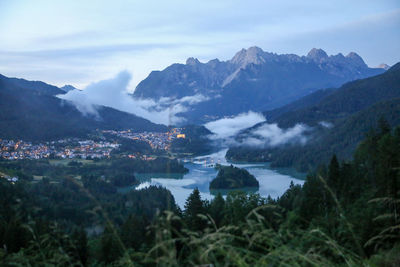 Scenic view of lake and mountains against sky