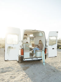 Freelancer working on laptop sitting in motor home