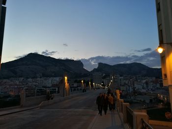 People at town square against sky during sunset