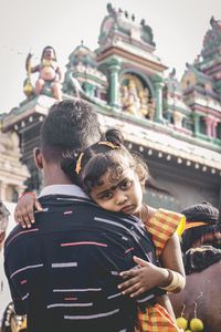 Rear view of friends at temple