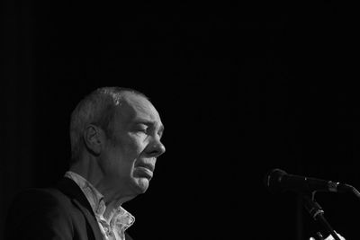 Portrait of a man against black background